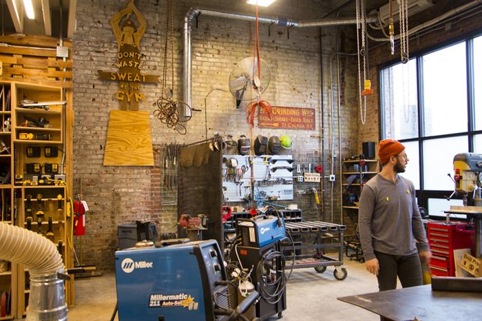 Nick Ward-Bopp works in his makerspace, Maker Village KC, which houses metalworking and woodworking equipment