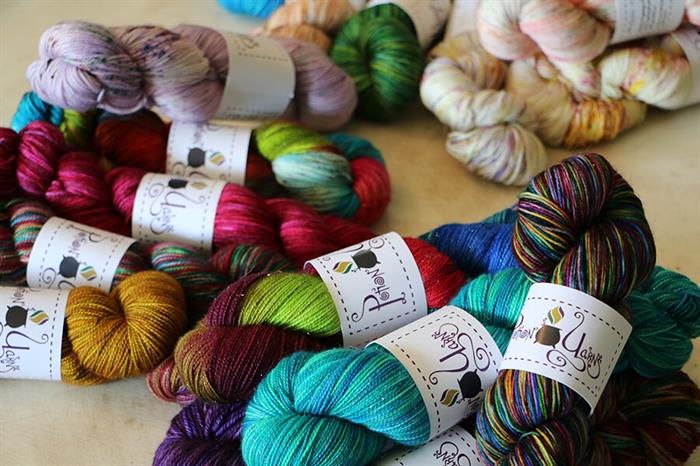 Multi-color hand-dyed yarns on display from KC maker Potion Yarns