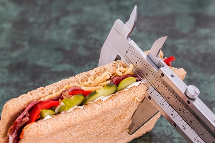 A sandwich is measured with calipers