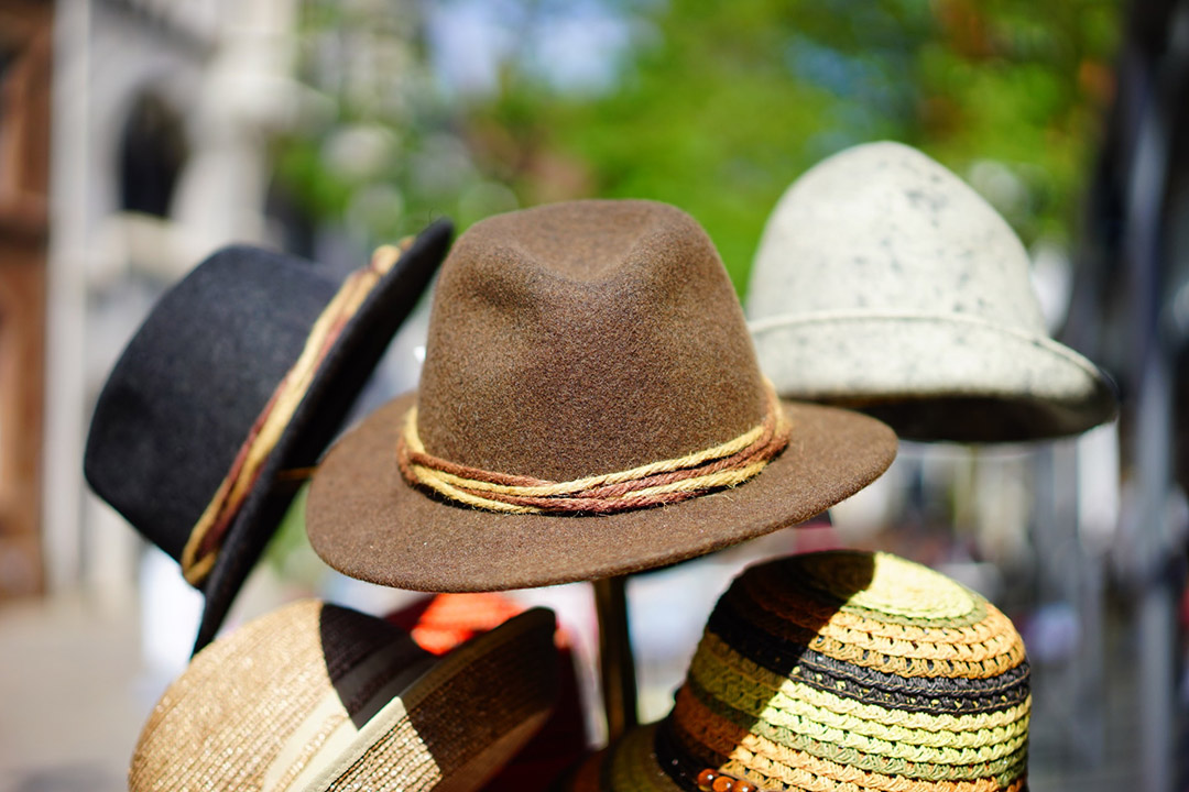 Hats rest on a rack outdoors