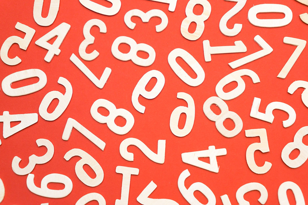 white numbers scattered on a red background