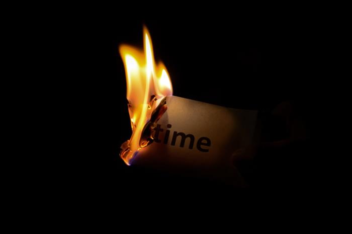 A piece of paper with the word "time" on it burns