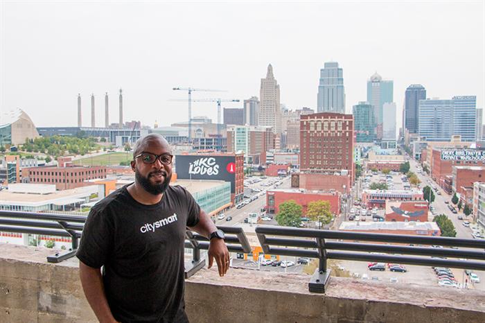 Donald Hawkins of CitySmart poses in front of the Kansas City skyline