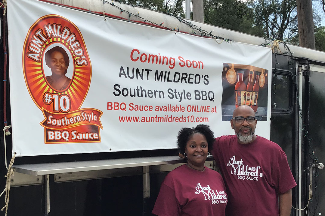 Earstin and Penelope Sanders pose outside Aunt Mildred's Barbecue Mobile Eatery