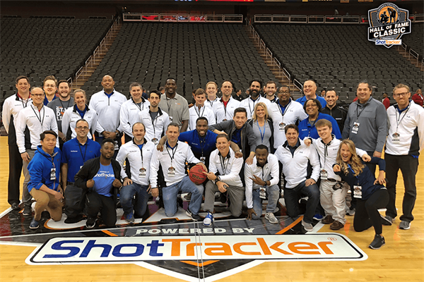 The ShotTracker team poses for a photo on a basketball court