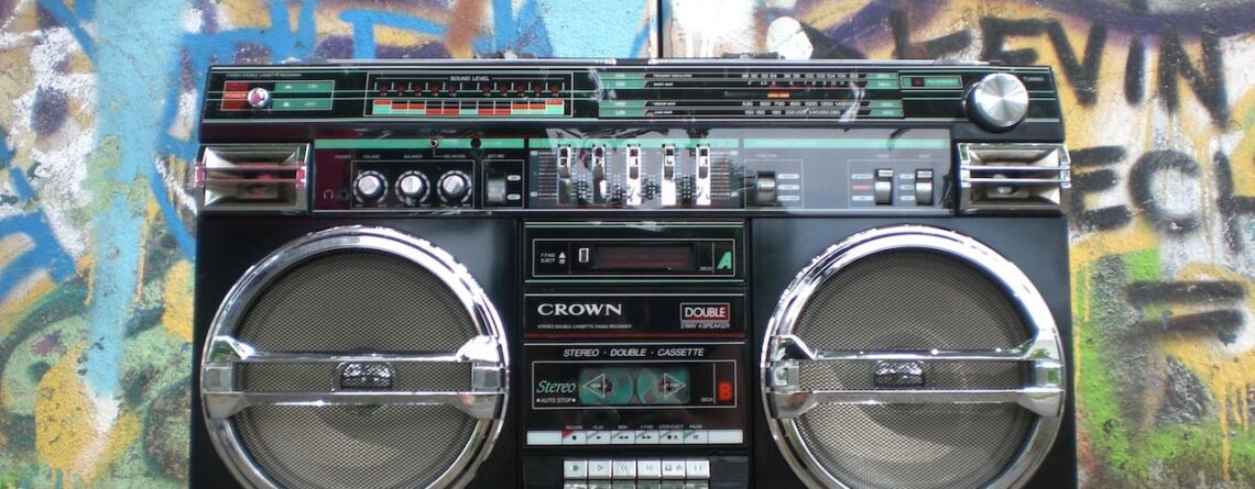 A boombox in front of a wall of graffiti