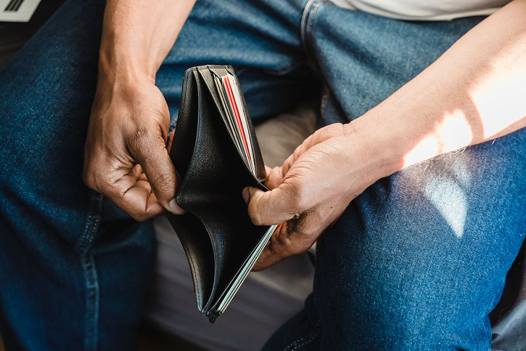 A man holds an empty wallet