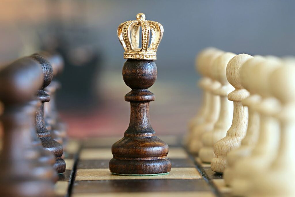 A pawn chess piece wears a crown