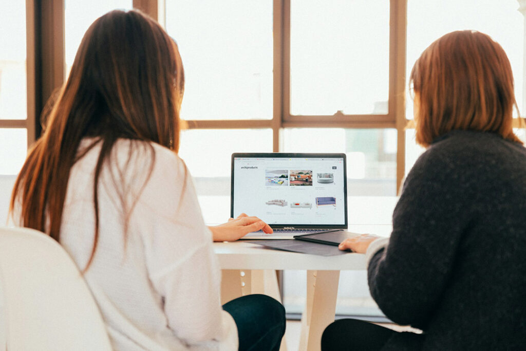 Two women browse a small business website