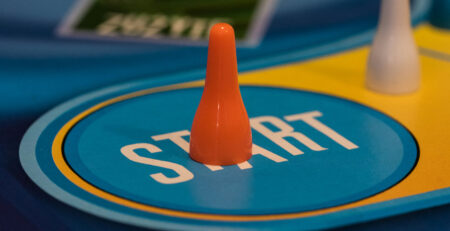 A board game piece sits on the start